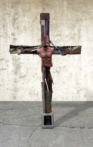 Artist Richard Cummings created this cross from discarded objects, transforming them as an act of redemption. During Holy Week a tattered torso is placed upon the cross as a wonderfully disconcerting reminder of Christ’s incarnation and sacrifice. The torso is removed before Easter Sunday and the cross remains bare for the rest of the year. (RichardWCummings.com)
